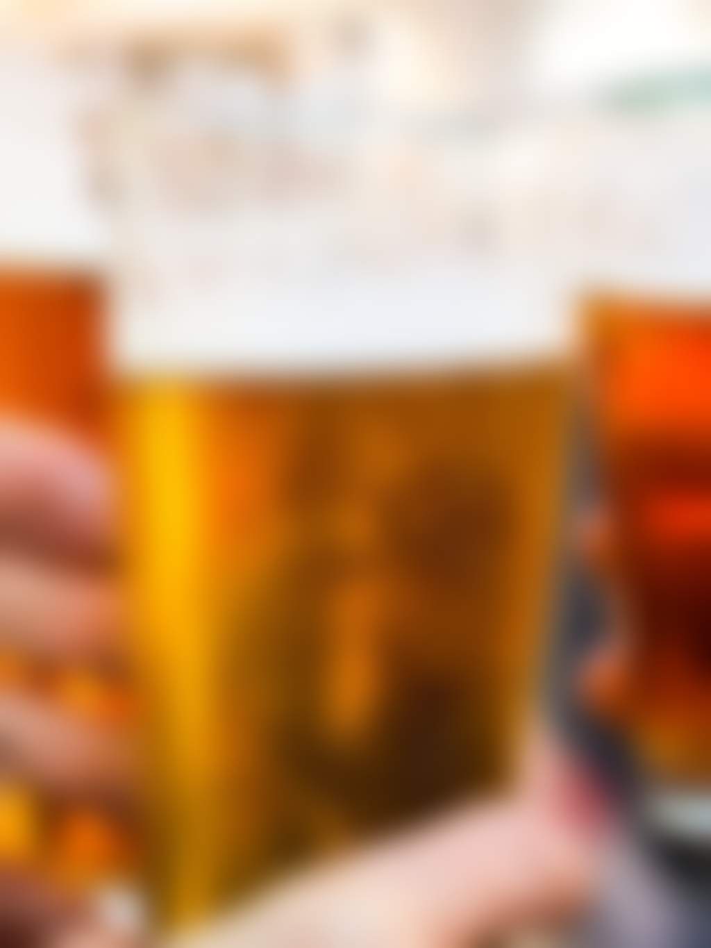 Three beers clinking glasses