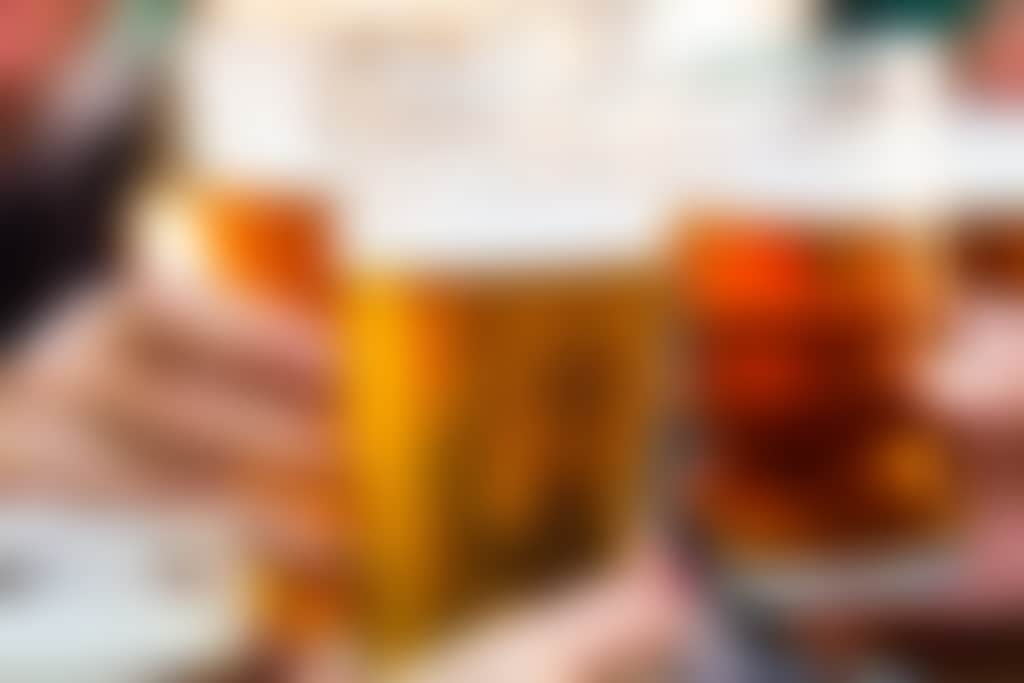 Three beers clinking glasses