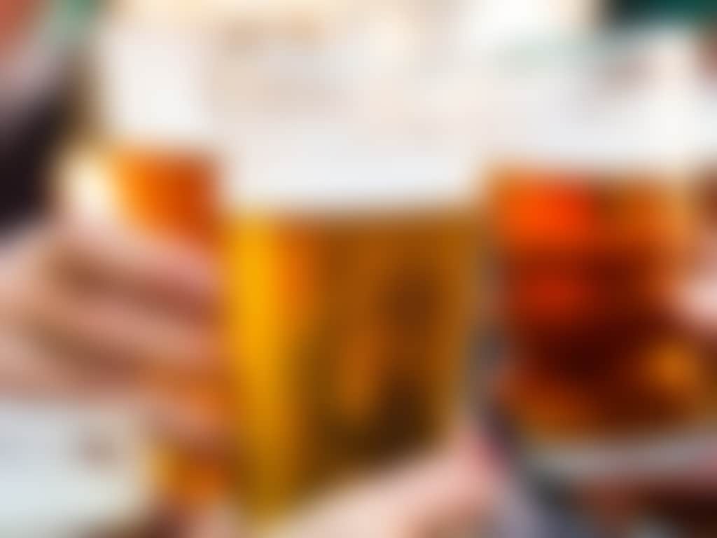 Three beers clinking glasses