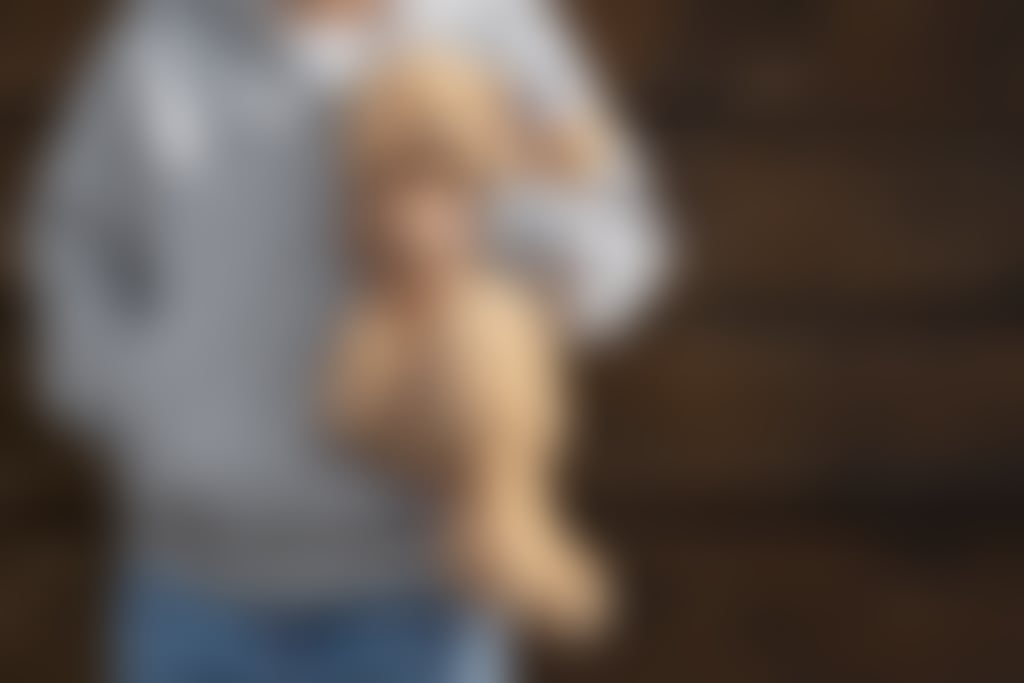 Kid holding teddy bear outdoors