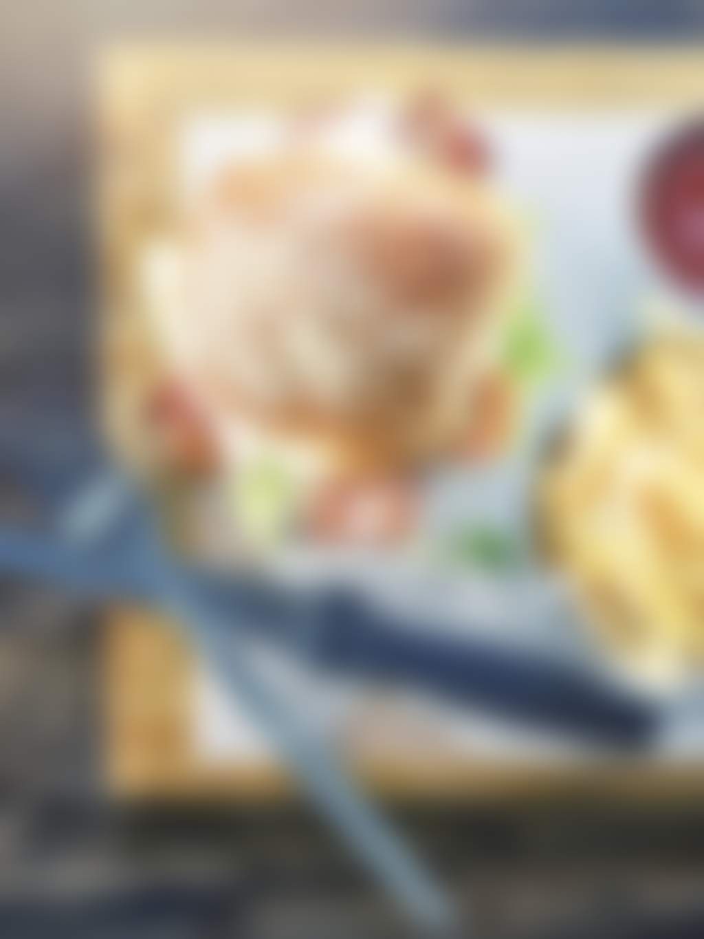 Burger and fries on wooden board