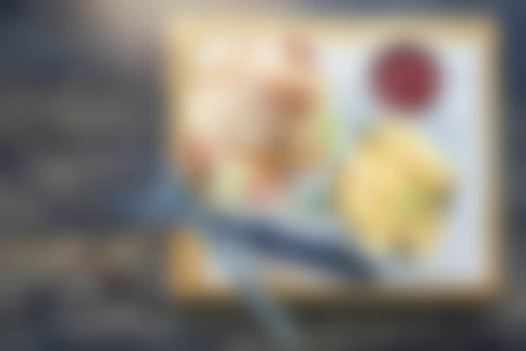 Burger and fries on wooden board