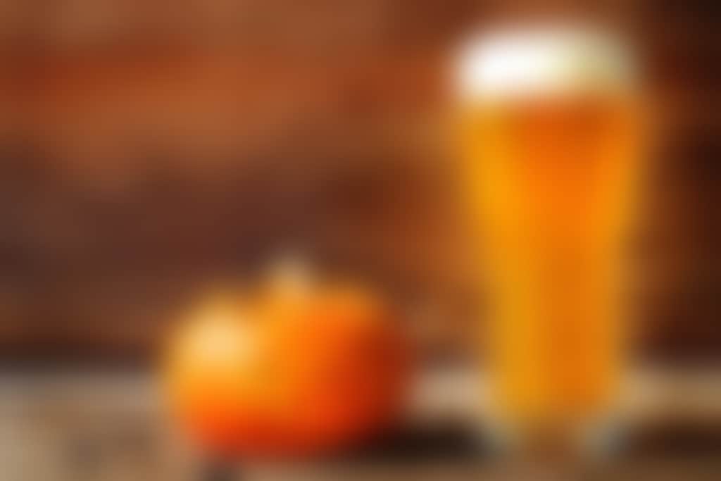 Halloween pumpkin and spiders with beer