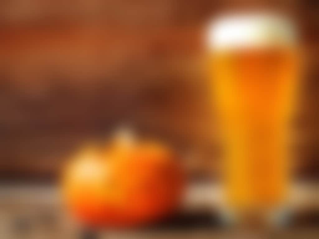 Halloween pumpkin and spiders with beer