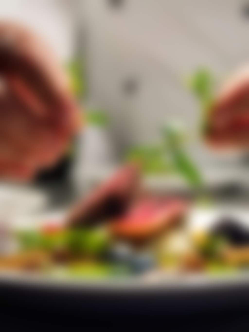 Chef garnishes beef dish