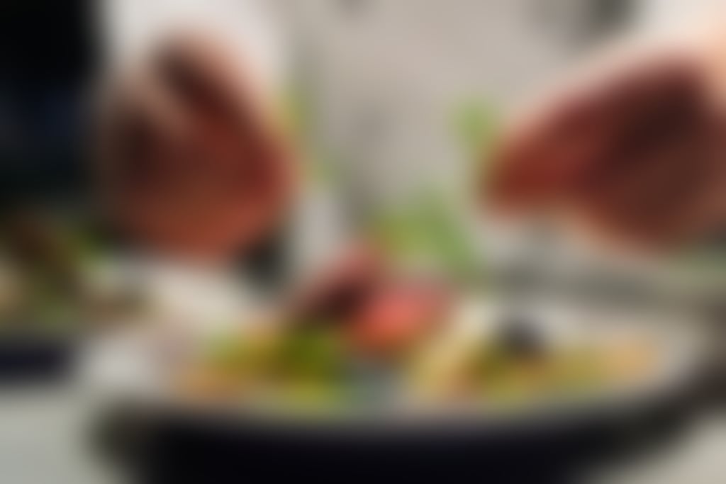 Chef garnishes beef dish